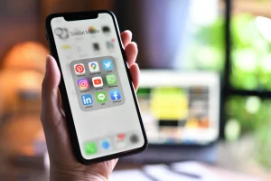 Female holding a smartphone with showing applications