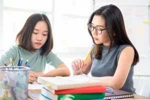 Female Asian University students study together