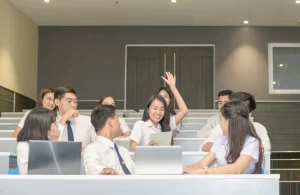 A young student raise hands in a class